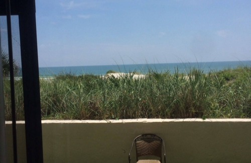 Crescent Beach Condo | Ocean Front Condo With Heated Pool outdoor patio overlooking the Ocean