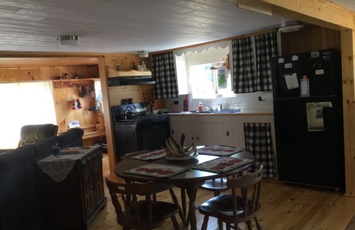 North New Portland Cottage | Paddle, float, fish, or rope swing into the near by crystal clear mountain lake.