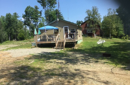 North New Portland Cottage | Paddle, float, fish, or rope swing into the near by crystal clear mountain lake.