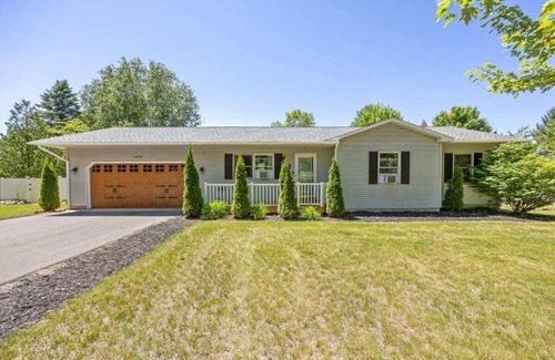 Grawn House | Pet-friendly home with fenced-in yard and hot tub