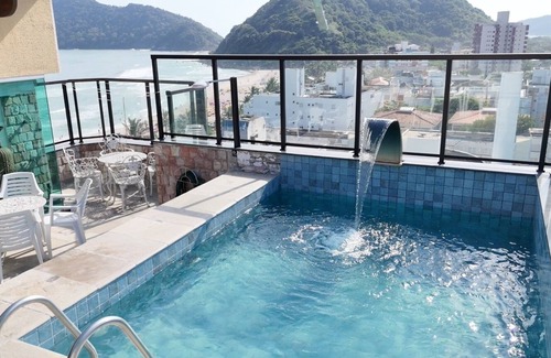 Guaiuba Apartment | Praia do Tombo Guarujá Coverage - Right on the sand, the best comfort for your family