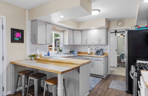 Huron House | Private ranch home with hot tub, playset, fire pit, and a nice lighted deck