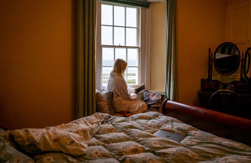 Laugharne Bed & Breakfast | Property looking at Dylan Thomas boat house and Laugharne Castle.