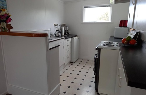 Foxton Beach House | Quaint comfortable convenient well appointed family bach.