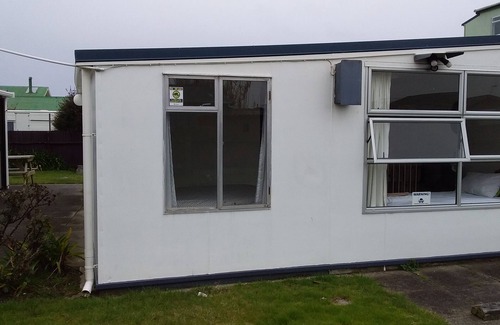 Foxton Beach House | Quaint comfortable convenient well appointed family bach.