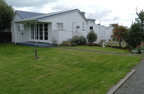 Foxton Beach House | Quaint comfortable convenient well appointed family bach.