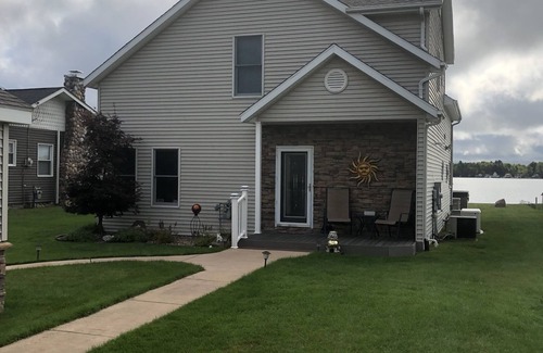 Lake House | Relax at the outdoor firepit or hot tub overlooking all-sports Eight Point Lake!