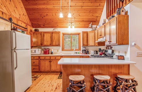 Lac du Flambeau Cabin | Riverfront vacation home with a dock, wood stove, full kitchen, & firepit