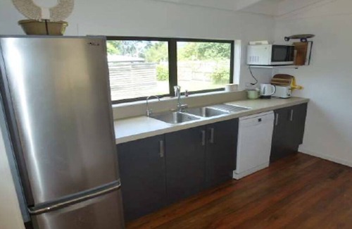 Whangamata House | Riverside Retreat - 3 Bedrooms + Fully Contained Sleepout + Hot Tub