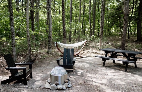 Woodstock RV Rental | Safari Tent Site 11 | 1 King Bed | Woods View