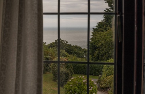 Colwyn Bay House | Seaview from bedroom, lounge and bathroom within an acre garden of tennis court