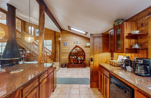 Volcano House | Serene 5-acre tropical hideaway with lanai and circular wood-burning fireplace