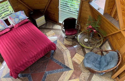 Orchidlands Estates Cottage | Solar powered bohemian loft cottage with birds, lizards, and frogs