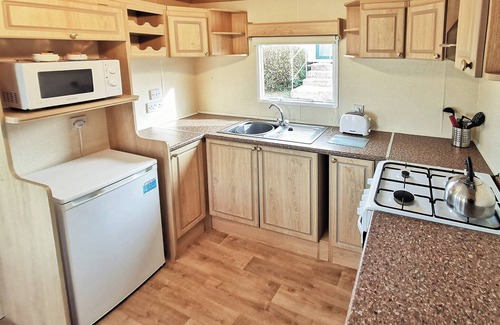 Aberystwyth House | Spacious 12ft-wide caravan with one double and one twin.