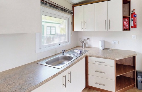 Llanllwchaiarn House | Spacious and well presented, 12-ft wide caravan with one double and one twin bedroom.