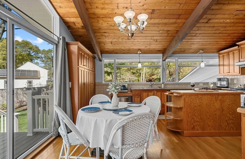 Sandwich House | Spacious dog-friendly property featuring a stunning backyard oasis with fire pits and outdoor bar