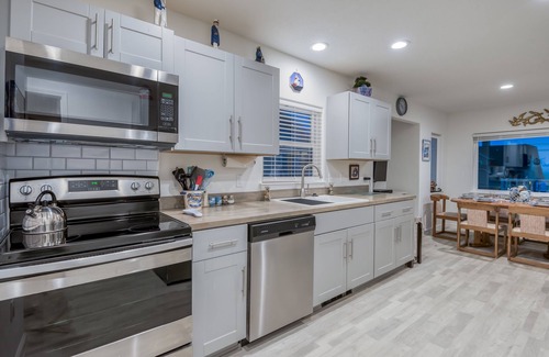 Nelscott House | Steps to the beach, ocean view, deck, BBQ, pet friendly with a fenced in yard