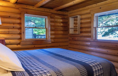 Walker Resort | Stunning Log Home on the water's edge with deck overlooking the swimming pool.
