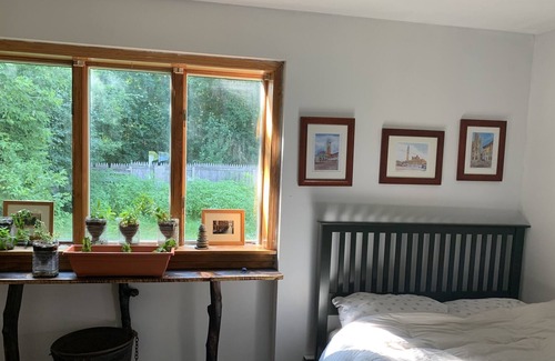 Waddington House | Sunny bedroom with full bed and private bathroom.