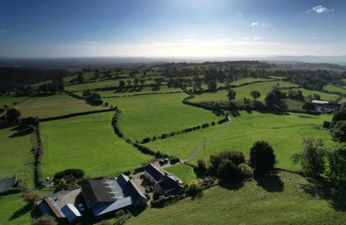 Oswestry House | The Barn at Pentregaer Ucha, with tennis court and lake