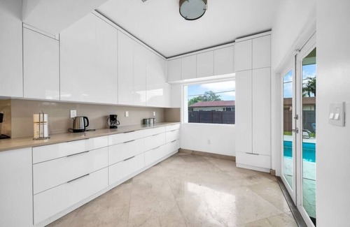 Ojus House | The modern villa with heated pool.