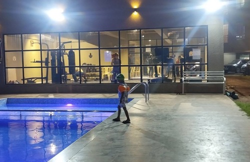 Mira Road East Apartment | The perchnOne cosy room with swimming pool and gym.