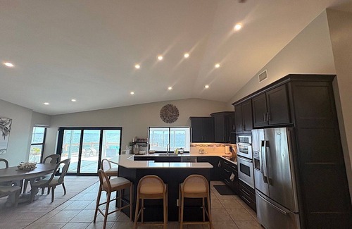 Caloosahatchee House | The River View 1008 - SE Cape Coral Riverfront Luxury Pool Home Pool Table and more