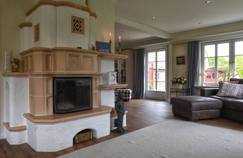 Nieblum House | The thatched-roof vacation home has 3 bedrooms and 2 bathrooms, and offers a large living area.