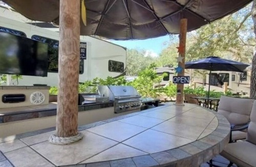 River Ranch RV Rental | Tiki "Glamping" unit fully stocked RV w/golf cart
