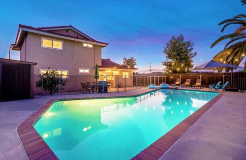 Rowland Heights House | Twilight Paradise: 4 Bedrooms, 2 Bathrooms, Private Pool, Patio Dining for 8, BBQ, and a One-of-a-Kind Indoor Fireplace.