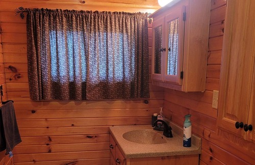 Kerr Cabin | Twin Oaks is a rustic and pet friendly cabin located on 50 mostly wooded acres