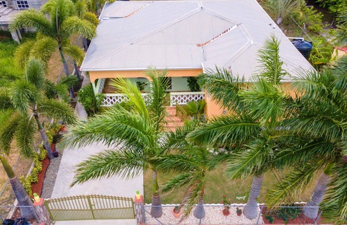 Cades Bay House | Two bedroom, 2 bathroom house in a tropical palm and garden setting.