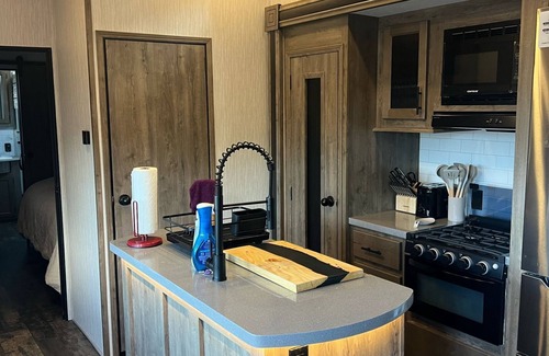 Lakeside House | Vacation Camper with private area behind with Seating, Firepit, and Hot tub