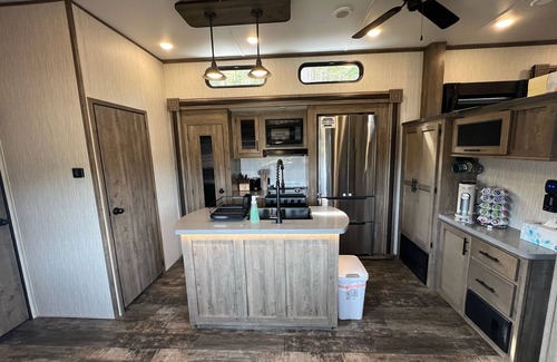 Lakeside House | Vacation Camper with private area behind with Seating, Firepit, and Hot tub