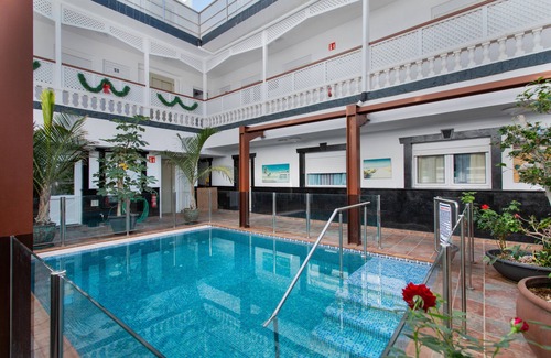 Playa de Arinaga Apartment | Vacation 'Casa Paula - 12' with Mountain View, Shared Pool and Wi-Fi