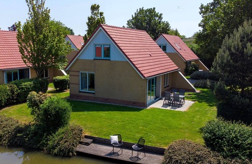 Andijk House | Villa in Friesland with Garden by Water