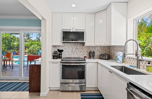 Poinsettia Heights House | Welcome to Pelican Landing, A Cozy Tropical Heated Pool Home!