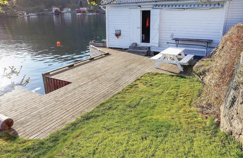 Flekkefjord House | Welcome to this charming vacation home situated on a natural plot that reaches down to the water.