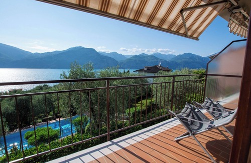 Assenza Apartment | Wonderful balcony on the lake with beautiful pool and garden among palm and olive trees