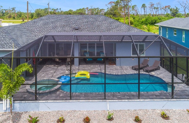 ALL the amenities! New home with hot tub, on canal, dock, pool heat included!