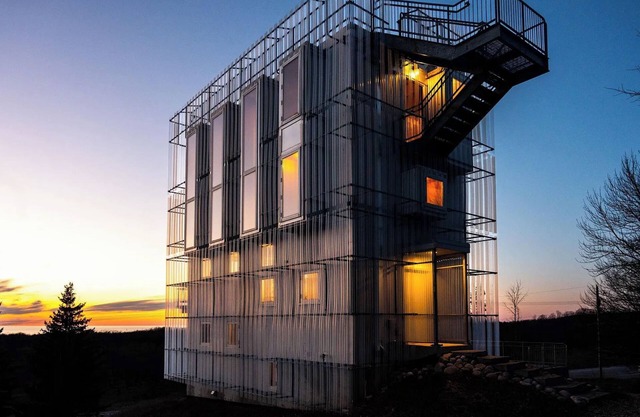 Award-winning 9-level Chameleon House in Leelanau County. A modern-industrial masterpiece with reflective siding, rooftop deck, and epic Lake Michigan views near beaches and Fishtown.