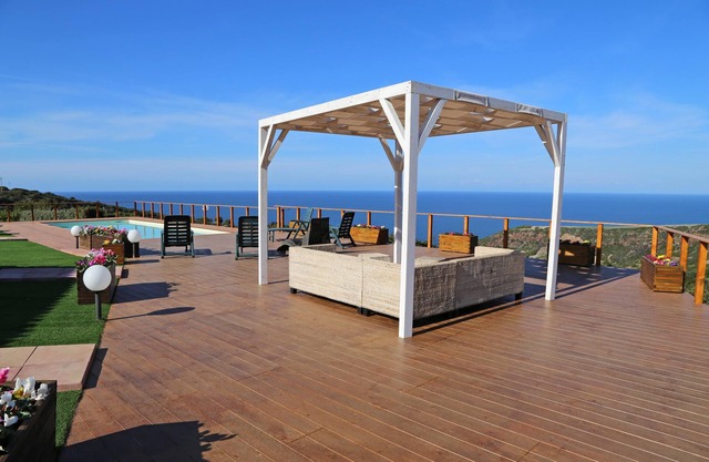 Bright villa with private pool, surrounded by lawn and sea view