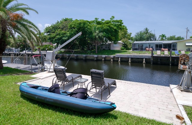 Canal-front home with pool, dock, patio, grill, sundeck, AC & washer/dryer