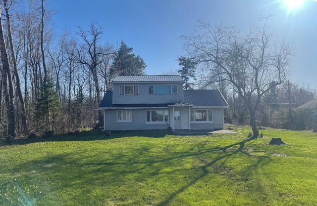 Charming house on the St. Mary's river in Sault Ste. Marie, freighters out front