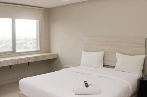 Cozy Studio at Gateway Park LRT City Jatibening Apartment By Travelio