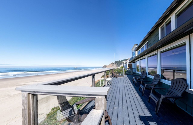 Enjoy the waves in the hot tub at this beachfront home with direct beach access