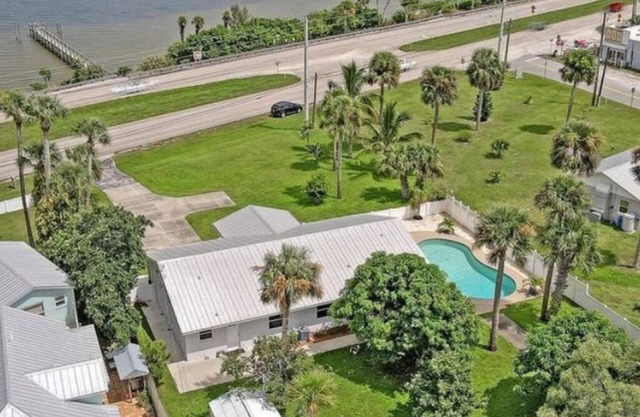 Indian River Waterfront Home with private dock, heated pool, fenced back yard