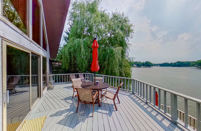 Lakefront home with spacious decks, lake views, hot tub, gas grill, & W/D