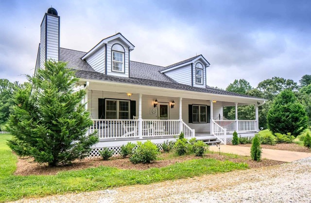 Modern and spacious home surrounded by scenic willow trees.