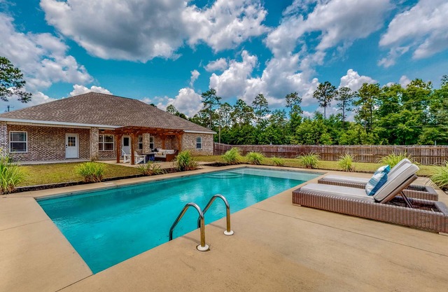 Nautical-themed retreat with a saltwater pool, fire table, full kitchen, and AC